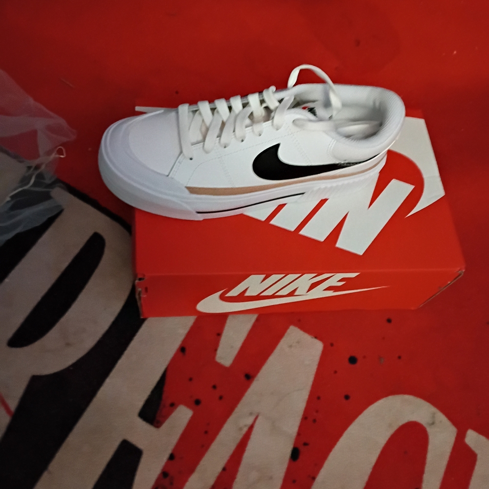 Nike Women's White Sneakers with Black Swoosh and Tan Accent